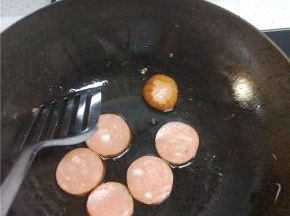 锅内放油，加热放入火腿，煎至两面微黄