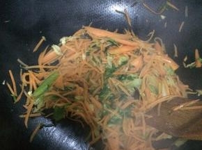 随后放入胡萝卜丝小火炒。