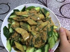 把搅拌好的麻汁洒在切好的黄瓜中，搅拌均匀。