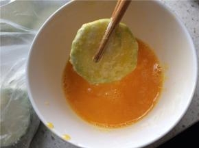 鸡蛋加盐打散，裹好面粉的西葫芦片放入蛋液中均匀地裹上蛋液