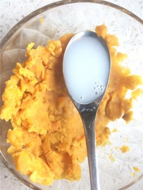 取出蒸熟的红薯，趁热加入牛奶压成细腻绵软的红薯泥。