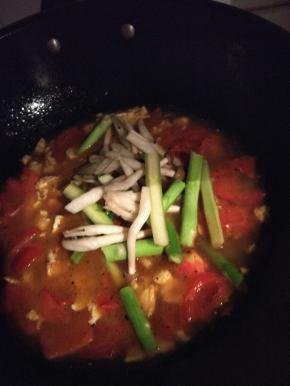 鸡蛋和番茄炒匀后加水，放入蟹味菇和芦笋（如果是生的玉米粒现在就加，熟的罐装玉米粒可以等面煮好后加）