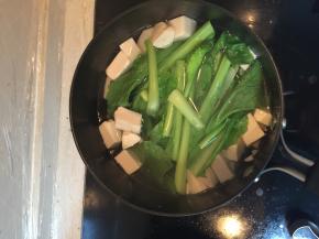 在锅里加入小青菜，继续煮开