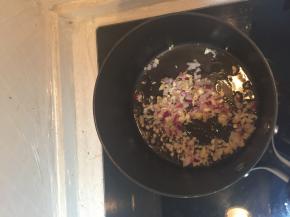 锅里加入油，把洋葱碎、姜蒜沫儿放在锅里炒香