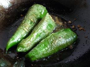 将拌好的肉馅塞入青椒里，锅里放入适量油温热，放入酿好的青椒中火煎黄起皱。