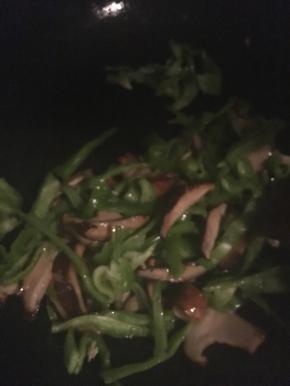 先炒香菇，香菇出水后再倒入青椒丝翻炒，