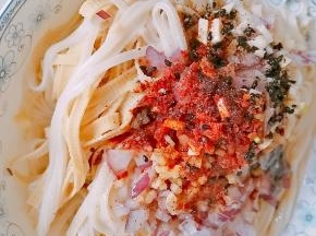 5.煮好后捞出，表面放上准配好的配料，洋葱末、姜蒜末、花椒粉、盐、鸡精、辣椒面、少许醋、酱油、芝麻。