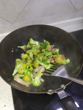 锅内放少许油，加入腊肉进行翻炒，倒入西蓝花