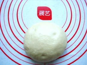 把面团放在垫子上排气。