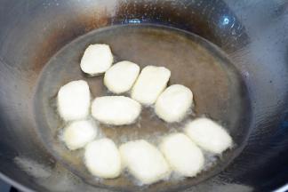 锅子烧干，放入植物油~
建议味道浅的植物油，如瓜子油或玉米油~
烧到油热（丢里一块马上能浮起的状态），
把年糕放入~