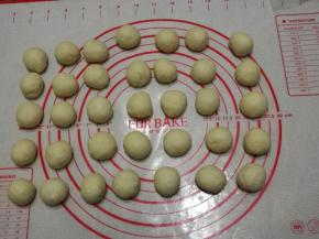 取出面团，稍微排气后，平均分成35个面团每个面团大约15克左右一个，把面团滚圆，保鲜膜覆盖松弛15分钟。