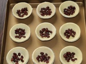 4把蛋挞里撒上适量蜜红豆，
