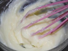 2隔热水用手动打蛋器打至顺滑，加入柠檬汁，拌匀。