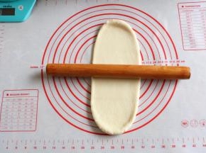 7取一个面团，用面杖擀成椭圆形。