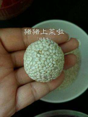 放进芝麻里滚一圈，再用手轻轻的搓一下，将芝麻按进去就可以了