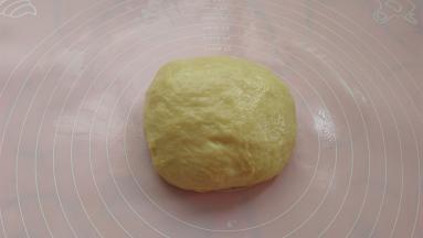 将发酵好的面团取出放揉面垫上，排气后滚圆静置15分钟