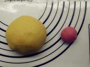 半个小时后，取出面团。因为我打算做成鸡爸爸、鸡妈妈、鸡宝宝三种大小，所以面团也分成不同大小。先将面团分出三个，分出一个105g（原色面团），一个90g（加色素做成黄色面团，其中15g做手脚嘴巴之类），一个10g（加色素做成红色面团），剩下的几克原色面团备用。