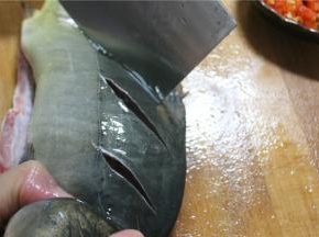 准备好一条1.3斤左右鱼洗净，剖开腹部，掏出内脏，去掉腹腔内的黑膜，切好花刀
