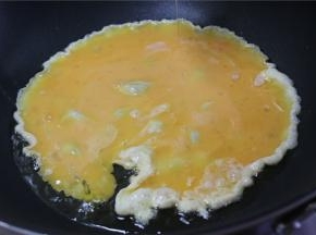 锅内倒少许的油，油热之后倒入鸭蛋，大火翻炒1分钟
