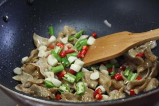 倒入切好的辣椒和蒜，翻炒出香味