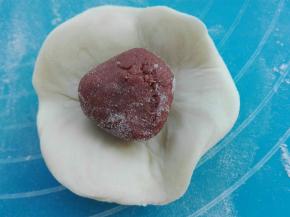 擀成中间厚周边薄，包上枣泥馅