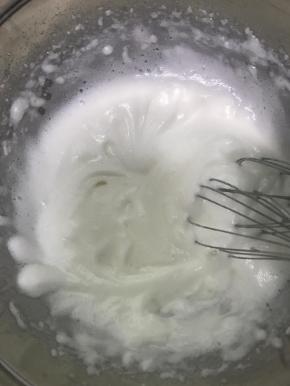 接着打到明显体积膨胀的时候，蛋白变多了，稍微有点细腻了，加入第二个四分之一砂糖，再说一句不矫情，看着倒就行，接着打，此时高速打发。