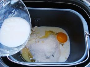 面包桶里打入一个鸡蛋，对角倒入盐，酵母粉。（盐与酵母粉不可直接接触，以免影响活性。）倒入白糖，玉米油，加入纯牛奶。