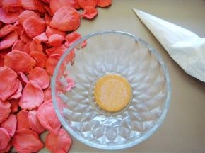 糖霜装入裱花袋，取一个饼干做花朵底托，放入小碗中（利用小碗的弧度支撑花朵，做花瓣的时候可以顺便做个饼干底托哦。）