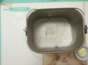 除黄油外的材料放入面包桶，启动揉面程序，揉成团后加入黄油。