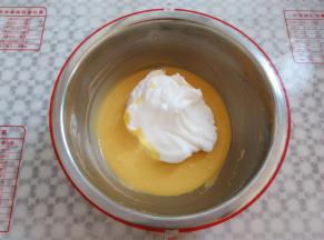 取三分之一蛋白霜放入蛋黄糊，2-8点钟方向手法翻拌均匀，这个时候预热烤箱上火120度，下火170度