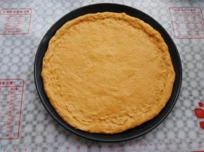擀成一个大饼皮，放入模具中，可以卷一个边，我用的12寸披萨盘