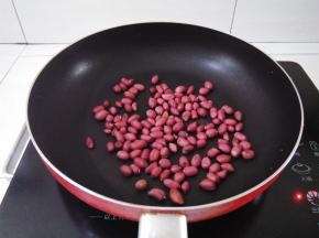 凉锅里倒入花生，小火翻炒2分钟