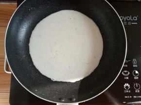 不粘锅里刷一点点油，倒入适量的面糊，平铺满锅底