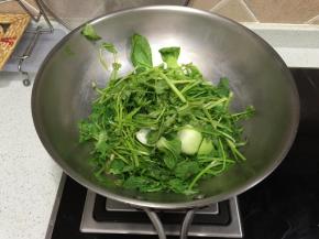 换一个锅，把洗干净的青菜铺在锅底