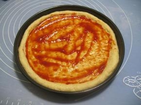 在饼皮上抹上番茄酱