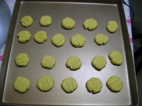 把圆球放在烤盘上，中间留一定空间，再用西餐叉将球形压扁。压出花纹