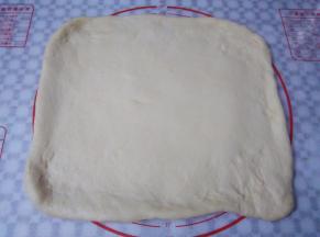 面团取出轻压排气，擀成25*35cm大小的面皮