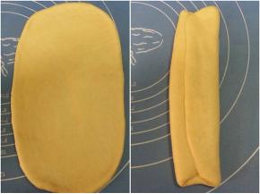 4. 取松驰好的面团，擀成椭圆形，翻面，抻平四角成长方形面片，面片两边向中间对折；