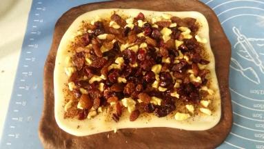 9. 依次放上核桃、葡萄干和蔓越莓干，轻轻压紧