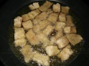 放入裹好面包糠的鳕鱼块中小火炸至一面金黄。