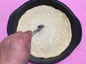 用叉子将披萨皮扎满小孔，避免烘烤时饼皮受热鼓起。