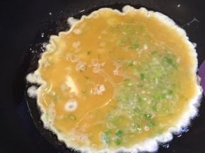 倒入蛋液，先不要翻动，转小火。慢慢把外圈和底部烙成稳定的型。