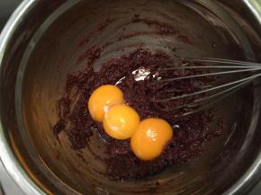 加入牛奶油混合物，拌至无干粉后磕入蛋黄