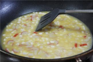 锅下油，烧至微微热之后倒入蛋黄小火翻炒，翻炒至周边冒小泡，起沙