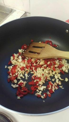 热油加入大蒜+辣椒，炒到香味出来，辣椒味道出来。