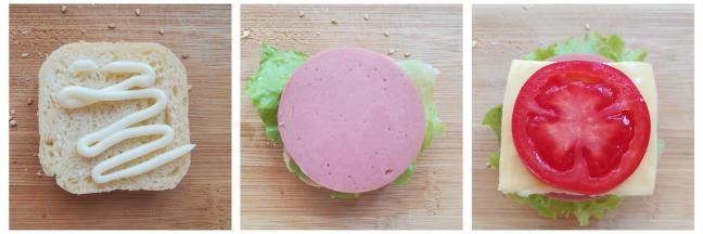 取一块面包挤上沙拉酱，放上生菜和火腿肠，再放上芝士片和番茄，最后盖上面包顶部