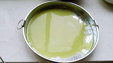 凉皮罗罗用油刷刷一层香油(或其它熟油防粘好揭)、倒入浆液，轻轻晃匀（薄厚你做几张就掌握住了，随意哈)。