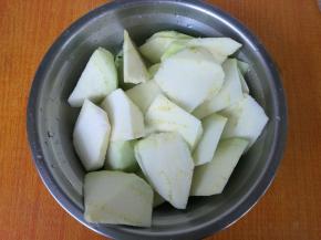 茄子去皮，切成坡刀块，放入1勺盐拌匀腌制。