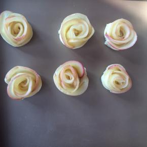 从面皮的一头开始卷起，卷好后的苹果就像是一朵玫瑰花。
烤箱预热170度20分钟即可。