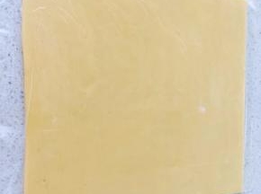 拌好的面团放到保鲜袋中，擀成3毫米厚的面片，放入冰箱里冷冻10分钟